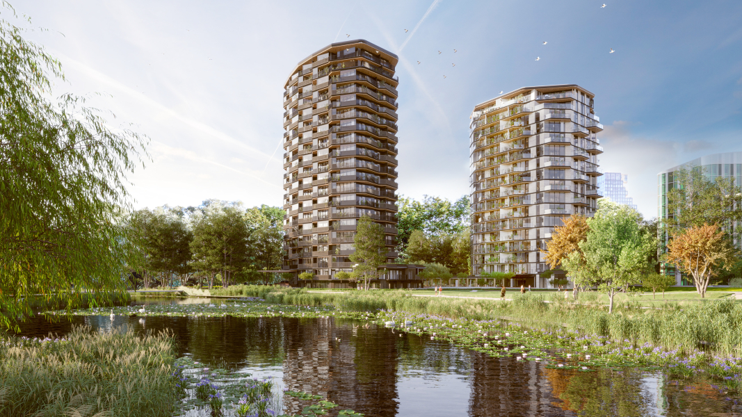Twee flats in een groene omgeving met een sloot op de voorgrond en bomen aan de rechterzijde